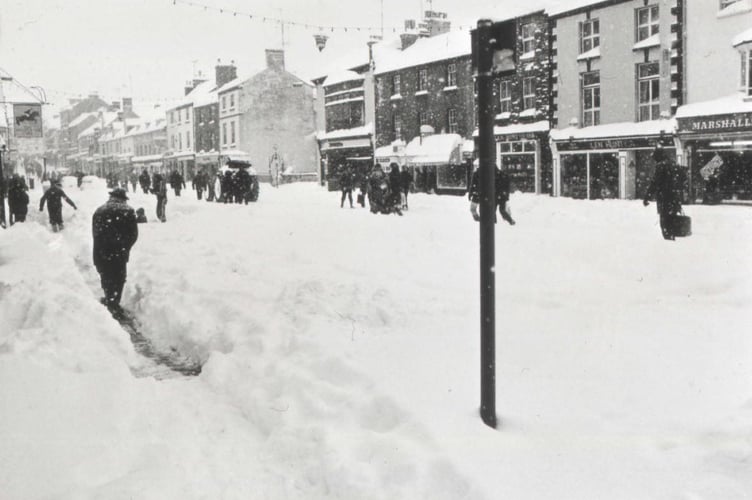 Monmothians digging paths in the snow through Monnow Street