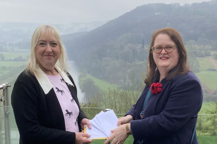 Mrs Sue Flower, from Yorkshire was holidaying in Llandogo when she took part in the Shop Local competition. Mrs Flower, left is seen here receiving her vouchers from Sherren McCabe-Finlayson, chair of Monmouth Chamber of Commerce