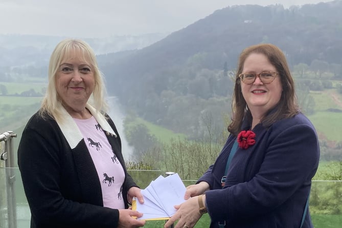 Mrs Sue Flower, from Yorkshire was holidaying in Llandogo when she took part in the Shop Local competition. Mrs Flower, left is seen here receiving her vouchers from Sherren McCabe-Finlayson, chair of Monmouth Chamber of Commerce