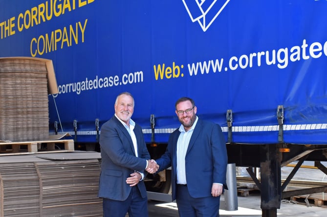 Tony Hession, chairman of  CCC seals the deal with  Gavin Peters, CEO, Tri-Wall  UK after Try-Wall takes over firm