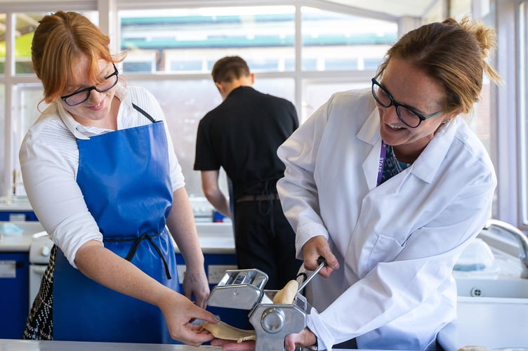 Pupil and teacher in cookery lesson  at Chepstow School
