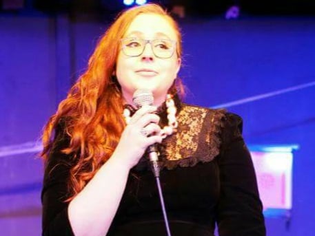 Welsh comedian Sianny Thomas on stage doing her stand up routine