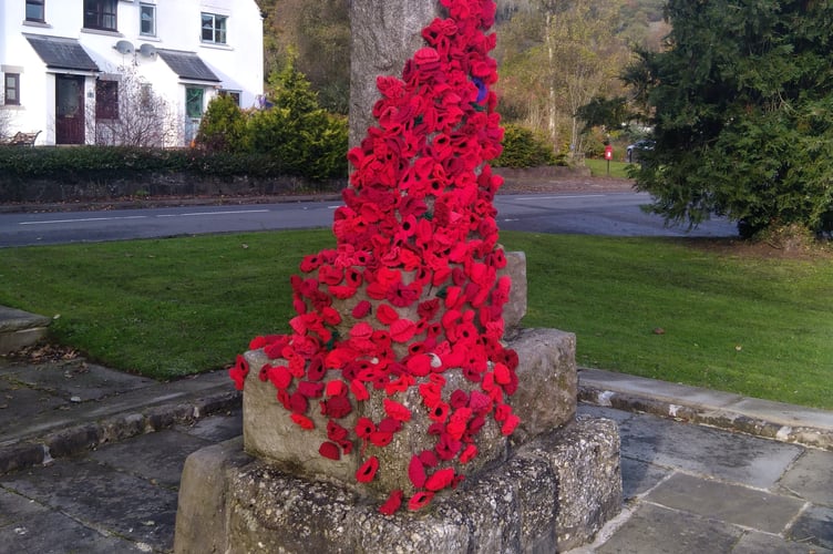 War memorial in Llandogo decorated with poppies made by  local WI members