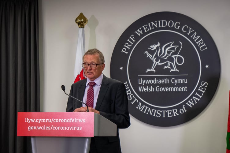 Pic of Dr Frank Atherton, chief medical officer of Wales, at a podium issuing a statement