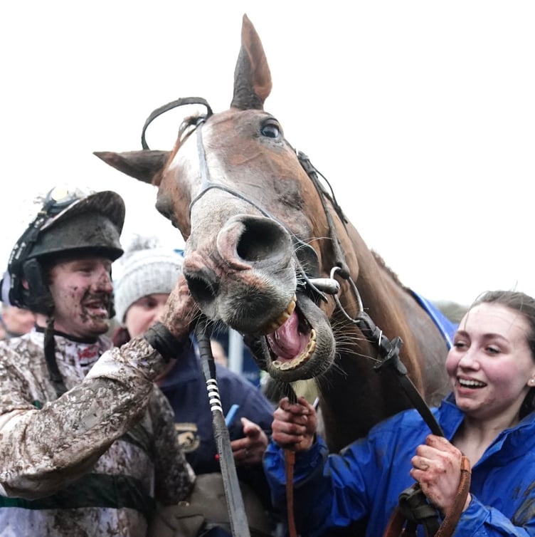 Jockey Caoilin Quinn and stable hand Gina Gibson celebrate after Nassalam 
cantered to Coral Welsh Grand National victory