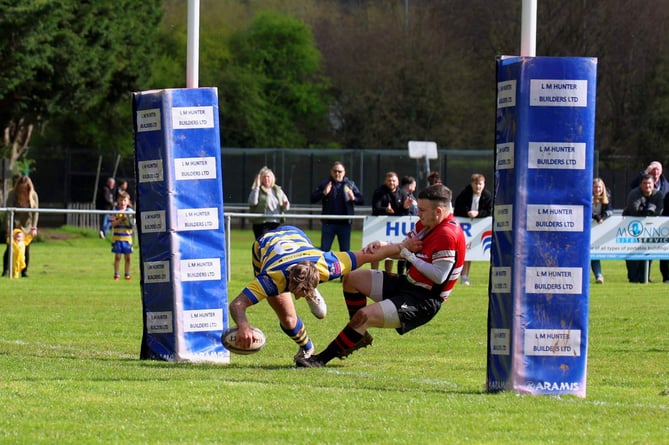 Ollie Scriven held off his opposite number to give Monmouth their opening try.jpg