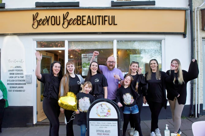 Rachel and Nick with their two daughters and staff celebrating the opening of the beauty parlour