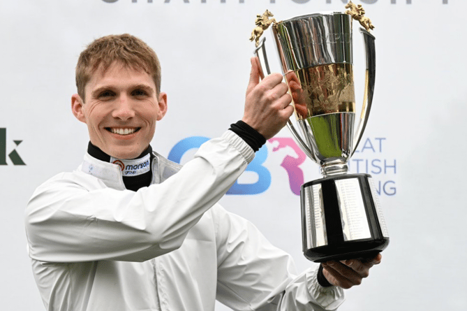 Harry Cobden with the Champion Jump Jockey trophy