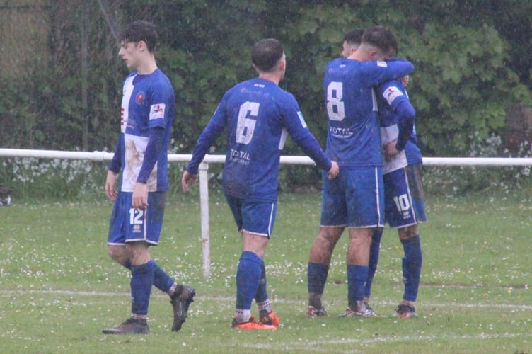 Chepstow celebrate their goal in lashing rain