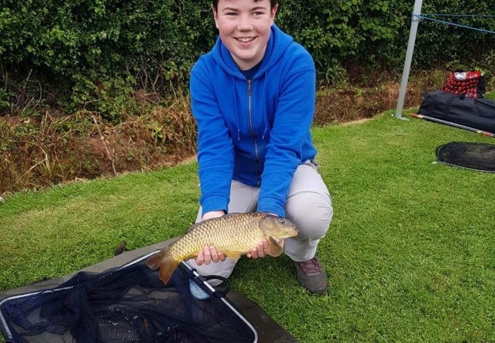 A happy angler with a common carp