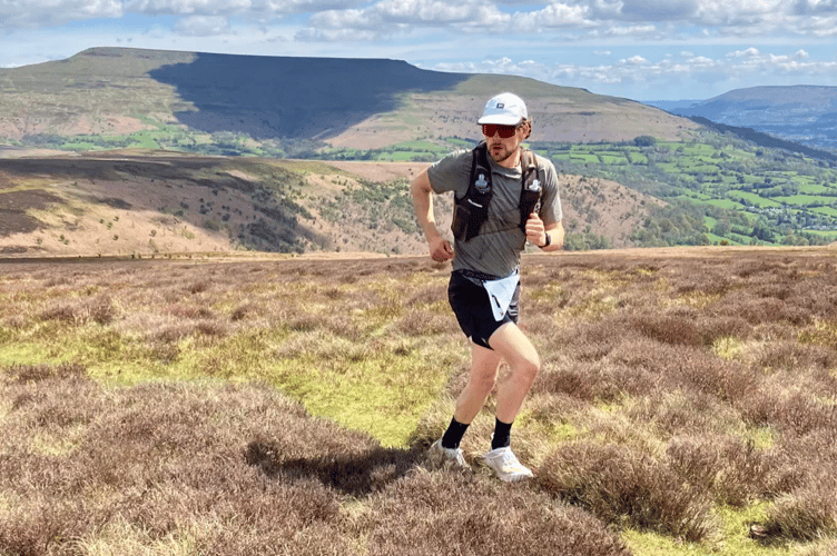 A runner strides out on top of the mountains