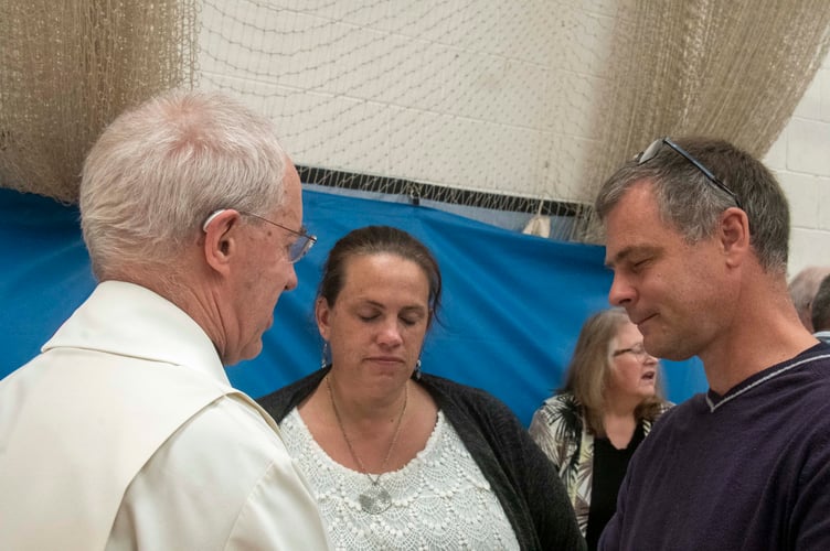 Kate and Gareth Birt of Woodcroft Christian Centre pray with the Archbishop.