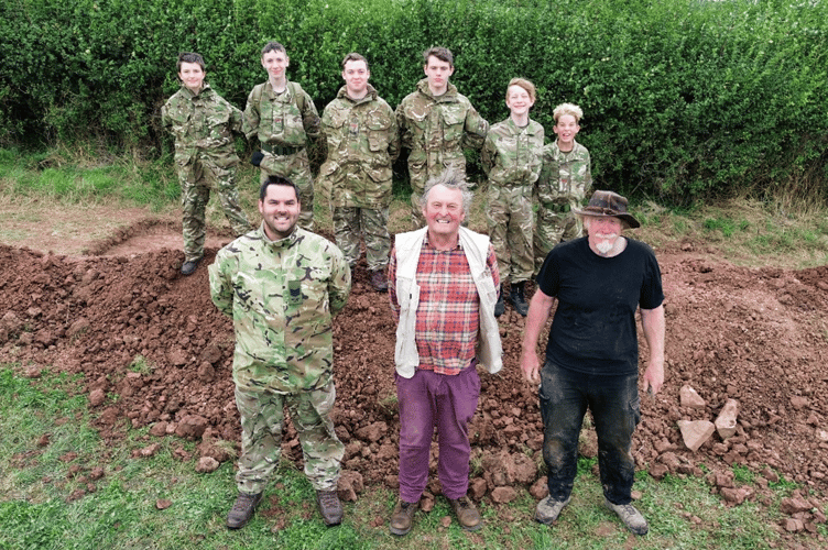 Cadets from C Company, Gloucestershire Army Cadet Force stand in front of their trench with Serjeant Instructor Ben Trimble, Professor Mark Horton and Chris Splotte from the Royal Agricultural University