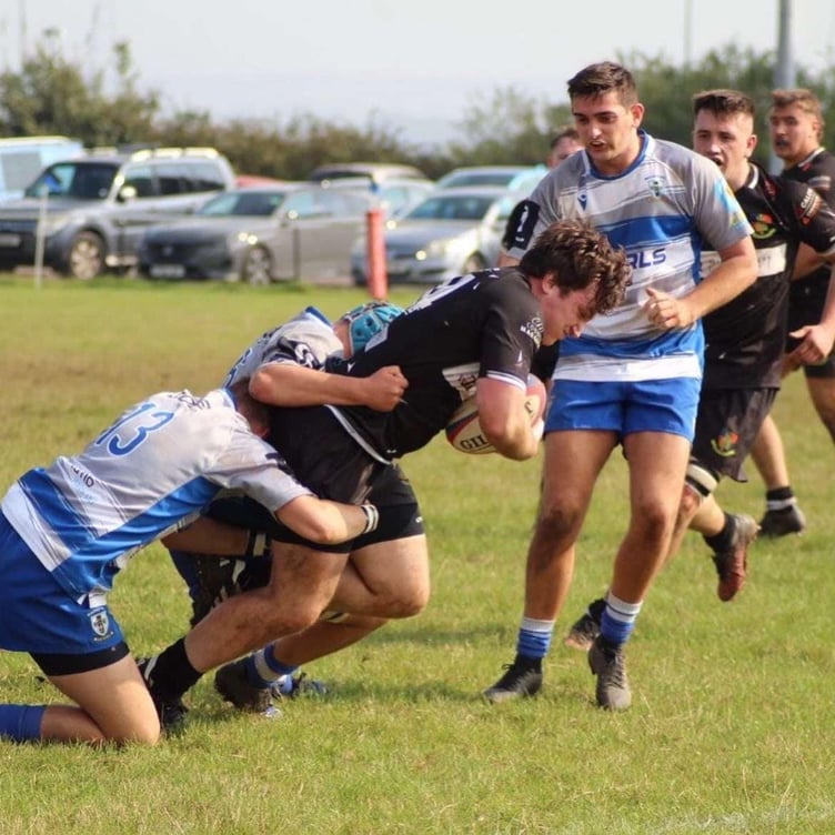 A Chepstow player drives against Machen