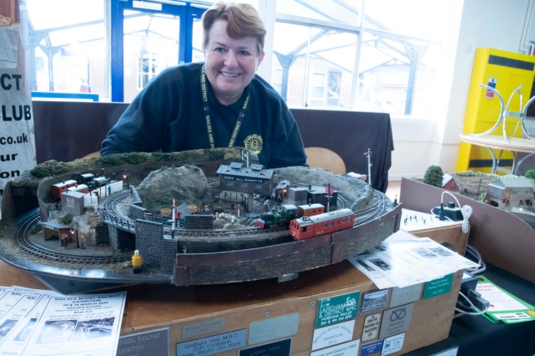 Heather  Hatch with a layout created by her father 60 years ago.