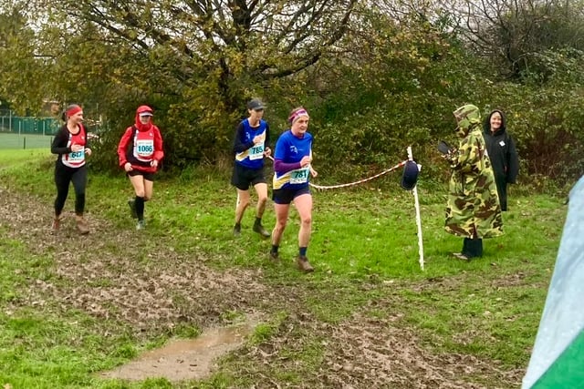 Runners brave the weather to storm home