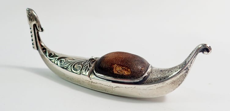 A silver gondola pin cushion