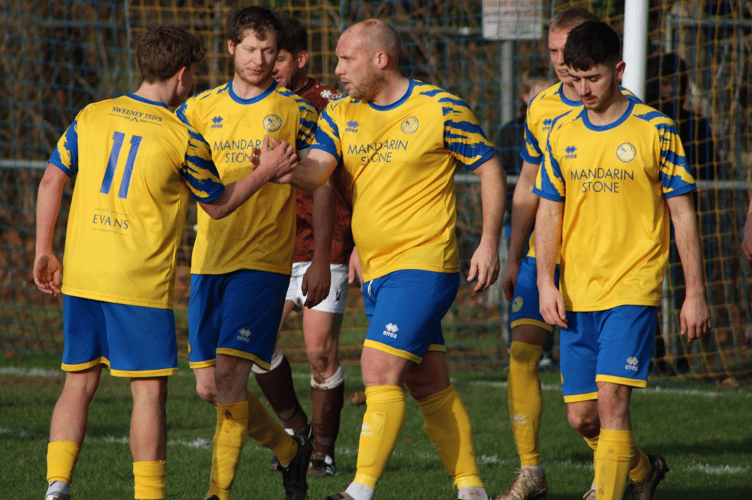 Kingfishers players congratulate Ron Laurie after opening the scoring
