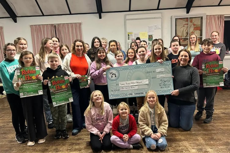 Photo attached of the Robin Hood & the Babes in the Wood chorus donating £200 to Louise Rixon, Community Fundraiser for Gwent Parent Carer Network. Abergavenny Pantomime Company