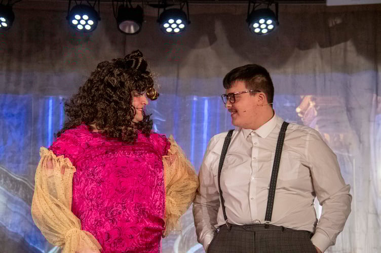 Dame Edna (NickTaylor) in a final change of costume with Dave (Jake Brice)