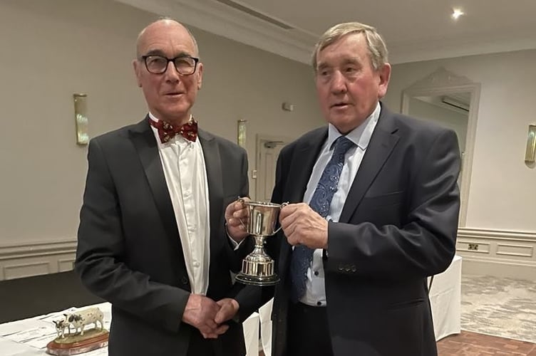 Kevin Rees-Davies presents Brian Cooke from St Briavels with a cup for a class in the farm class competition.