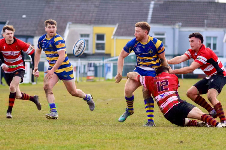 Harry Whelan who scored the Monmouth try passes to Morgen Jeffs