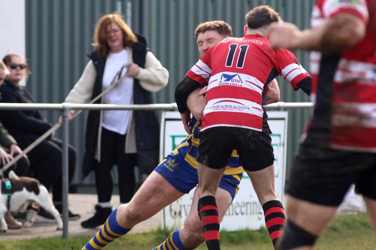 Ouch! Harry Whelan runs into a solid tackle