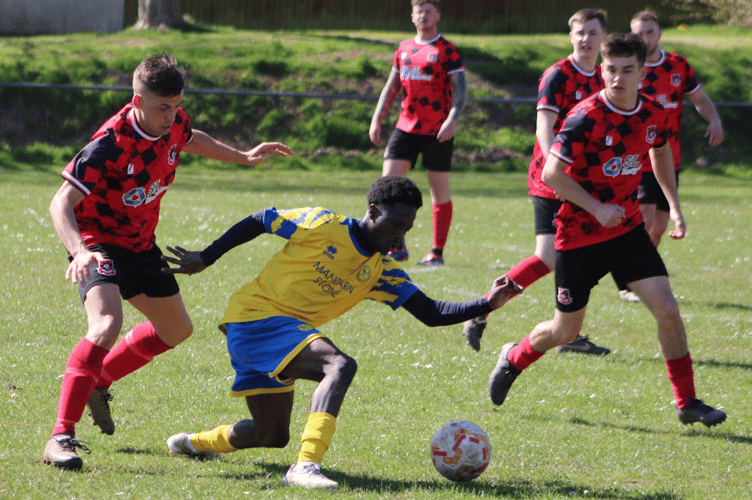 Ebil Ndure is surrounded by New Inn players