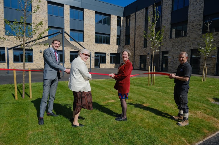  Leader Mary Ann Brocklesby and Chair of the Council Su McConnel, along with other Monmouthshire County Council staff, being handed the keys to the new King Henry VIII 3-19 school in Abergavenny by representatives of Morgan Sindall.