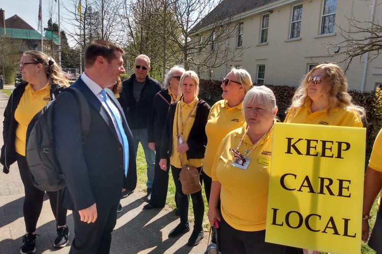Conservative opposition group leader Richard John talks to Lougher Home Care workers outside County Hall, Usk.