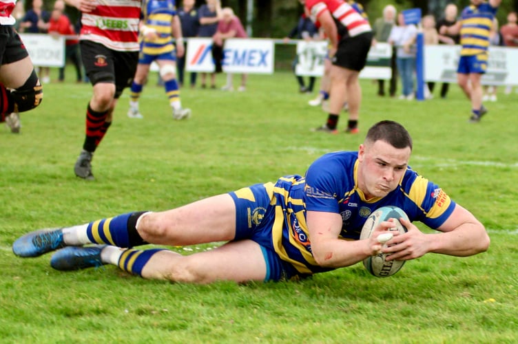 Lewis Bates crosses for one of his three tries
