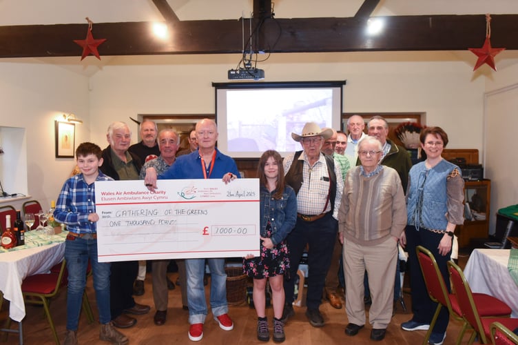 Pictured are Gathering of the Greens enthusiasts presenting their donation to Rob Evans of the Wales Air Ambulance.