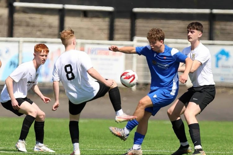 A Monmouth player battles for the ball with three Bryntirion players
