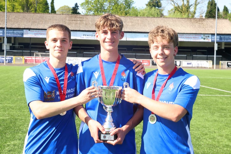 Monmouth's three goalscorers Herbie Perry. Lucas Harris and George Gouldingay get their hands on the cup