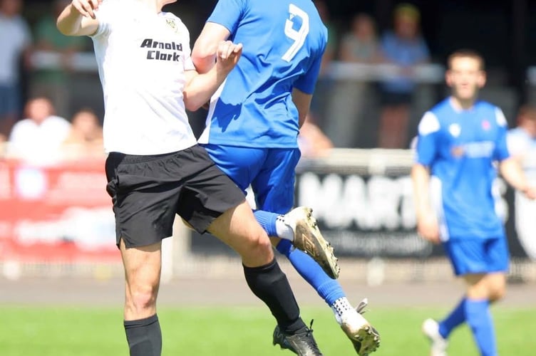 Callum Wilding leaps for the ball