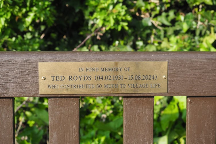 The plaque attached to the bench