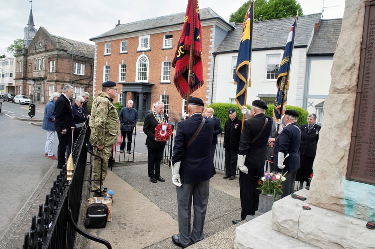 The mayor lays a wreath along with Jim Hodgson and Louise Orr at the was memorial