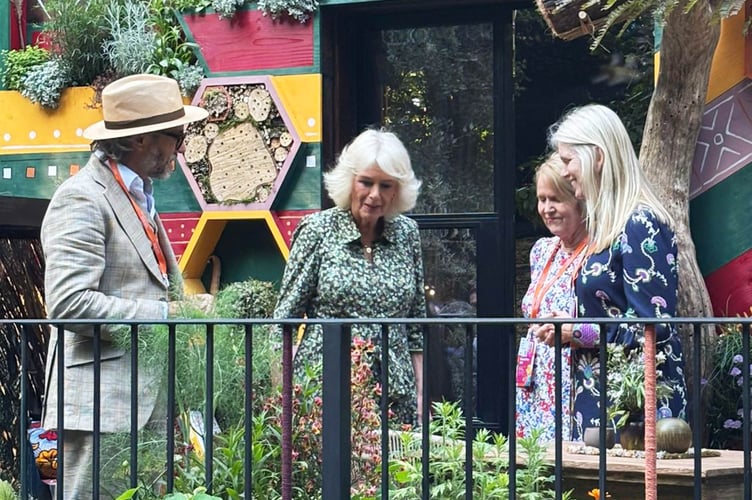 Her Majesty The Queen with Megan Denver CEO Bees for Development, Steve Benbow Royal Beekeeper and Gill Smith Director EH Thorne Ltd - 
