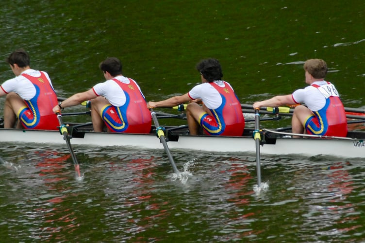 A quad scull storms home