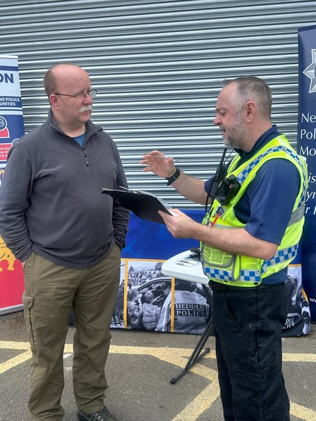 A police officer provides advice to a Screwfix customer