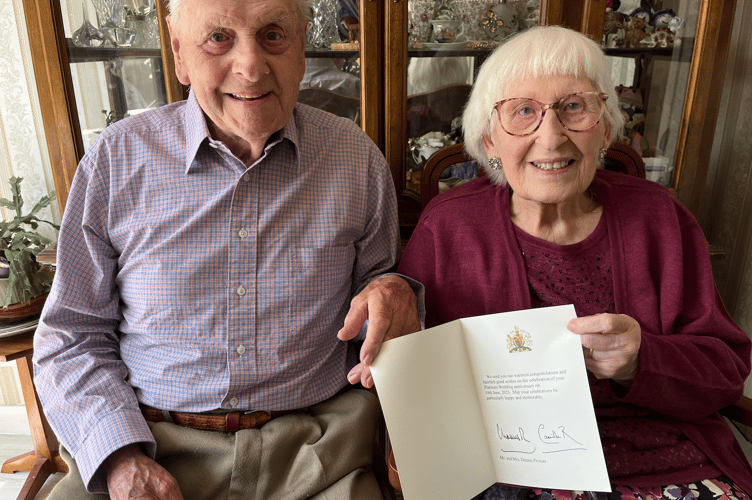 Dennis and Margaret with their card from the king 