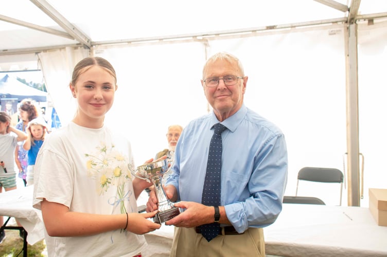 Eira Reeves was presented with the John Evans Cup for the best rose by show president Alan Morgan