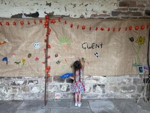 The impressive 7m X 1.5m Community Wall Mural displayed in the barn