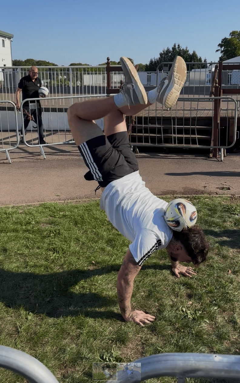 Jay Rosa speaking into a microphone on a football pitch
