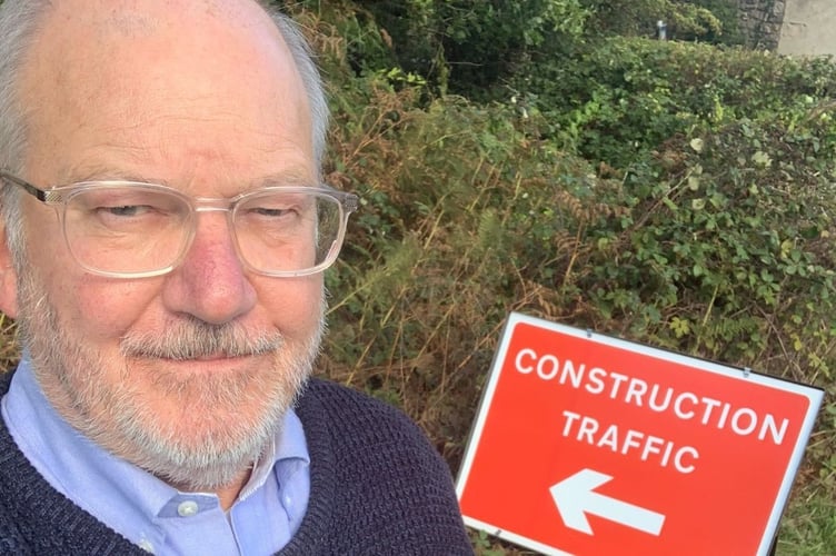 Alistair Neill with a construction traffic sign for an under construction solar park. 