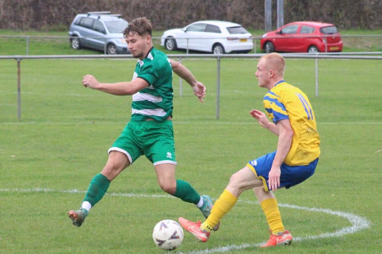 A Kingfishers player goes toe to toe with a PILCS player