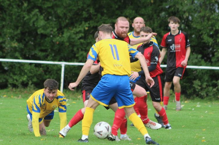 The balls in there somewhere, as Monmouth and Lucas players fight for possession