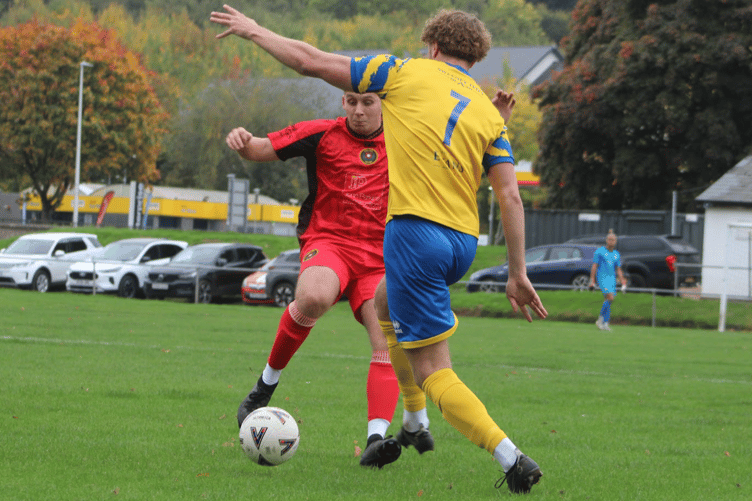 Players challenge for the ball in the Monmouth v Pill match