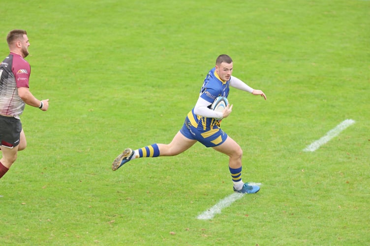 Lewis Bates swerves to avoid the defence having intercepted