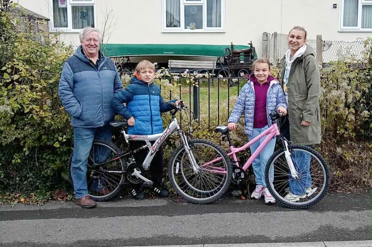 Mark and Kamilla with their new bikes with David Evans, left, and mum Anastasia, right.